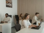 Four people working in call center office