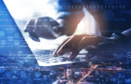 Double exposure of man working on laptop computer with city, binary and technology element.